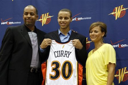 Stephen Curry will don the Golden State Warriors uniform. Curry is joined by his father, Dell (left), and mother, Sonya. 