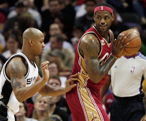 LeBron James, right, is defended by Spurs guard Keith Bogans during a preseason game in San Antonio. (ASSOCIATED PRESS)