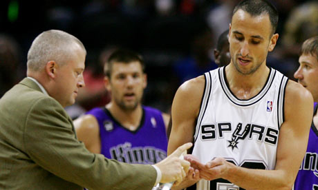 A trainer sanitizes Manu Ginobili's hands after his close encounter with a bat.
