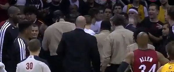 A young fan who interrupted the Heat-Cavs game is escorted out of the court. (SUN SPORTS SCREEN GRAB)