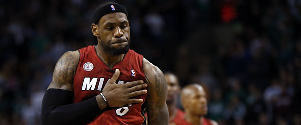 LeBron James thumps his chest after hitting the go-ahead jumper against the Celtics. (REUTERS)